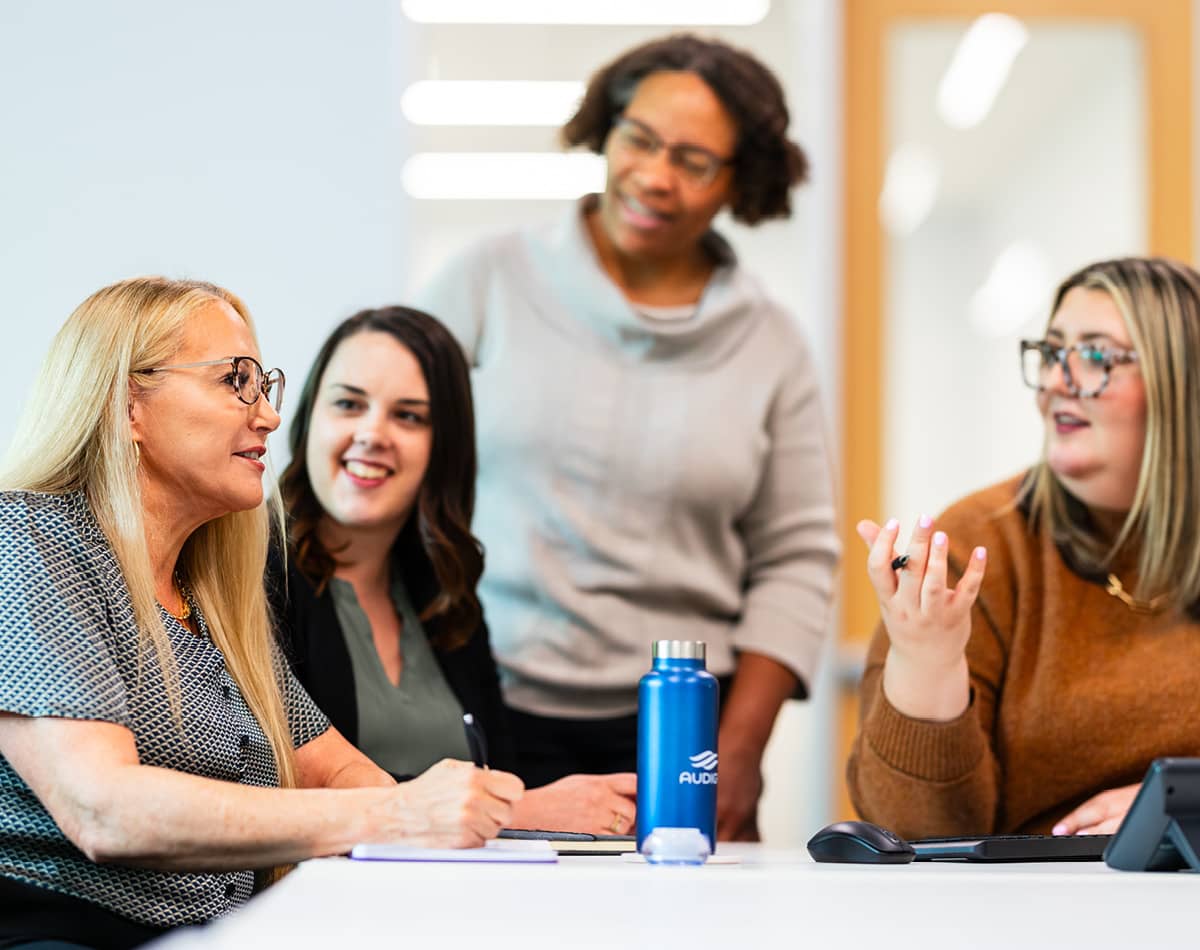 Four professional women meeting