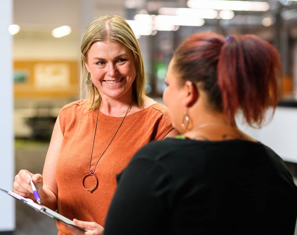 Two women talking in a professional space