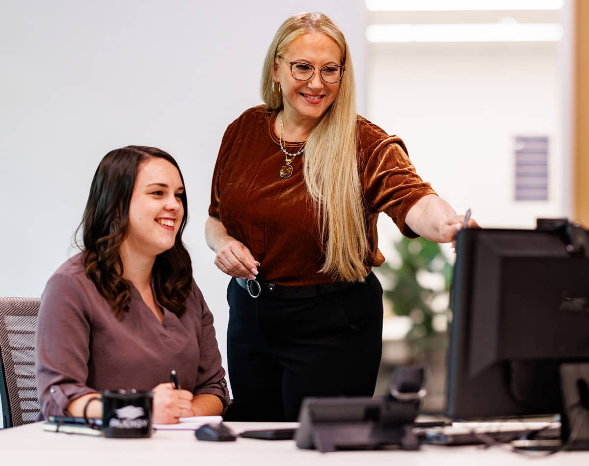 Two women meeting in front of a computer