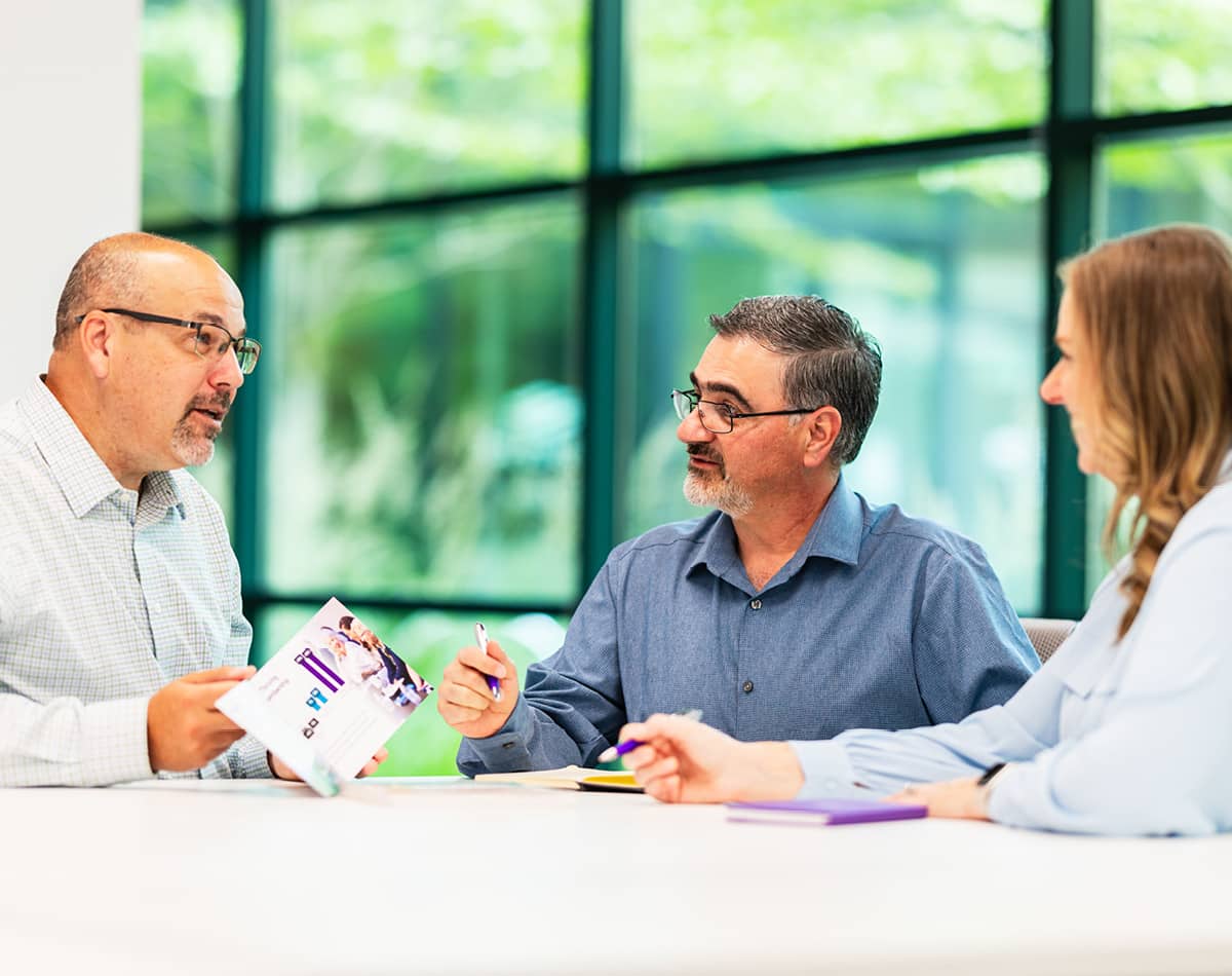 Three professionals in discussion