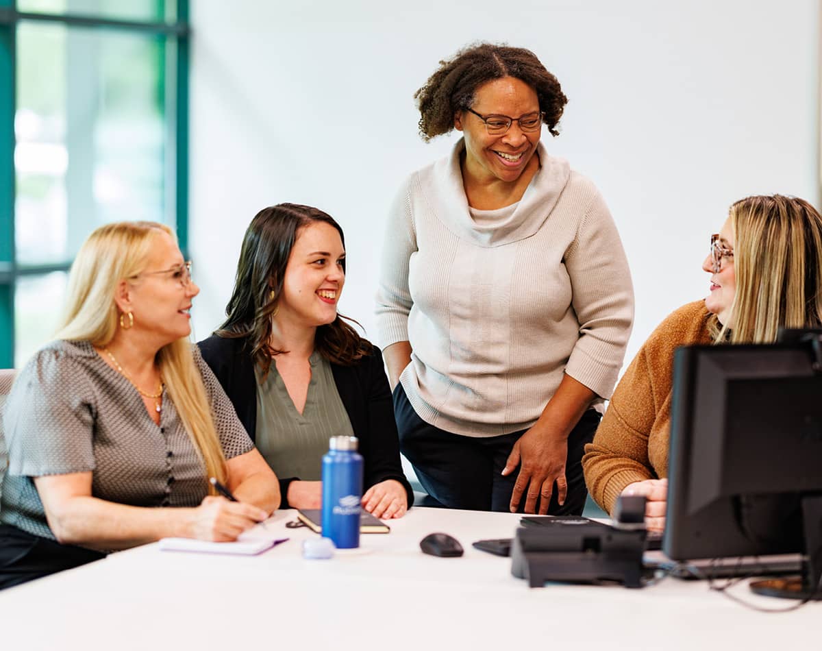 Four professional women meeting