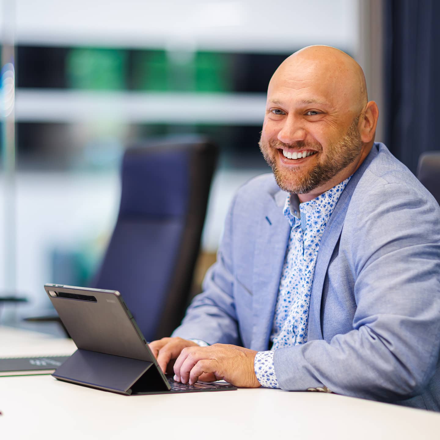 Man sitting at a desk with an ipad