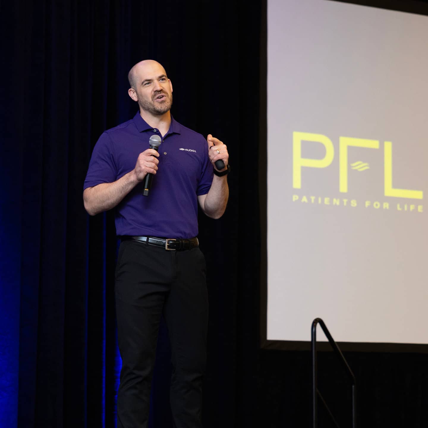 A man presenting on stage