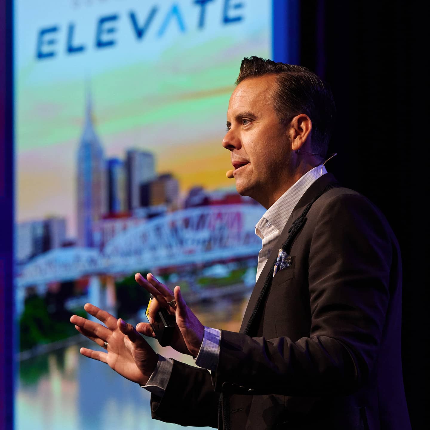 A man presenting on stage