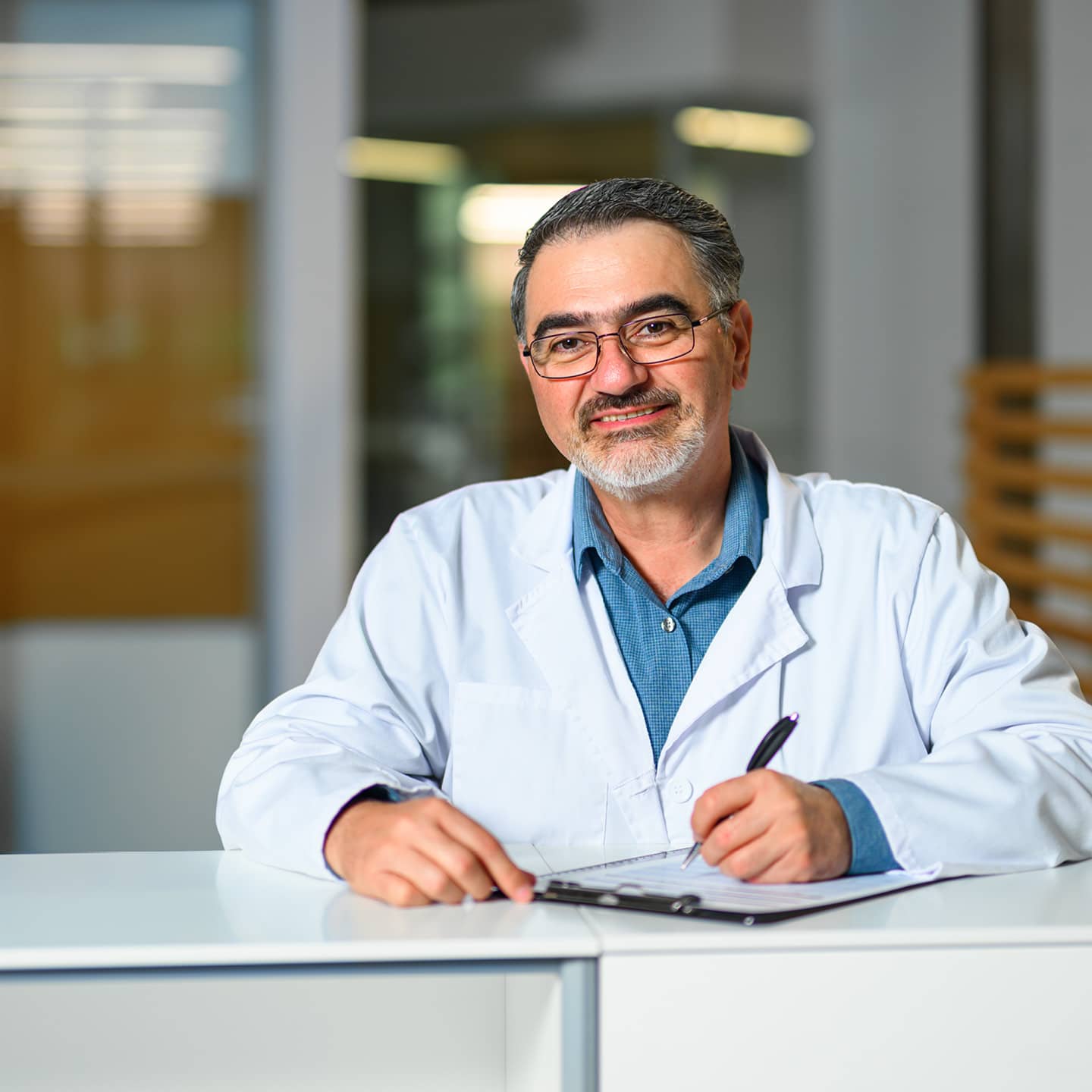 A male medical professional smiling at the viewer.