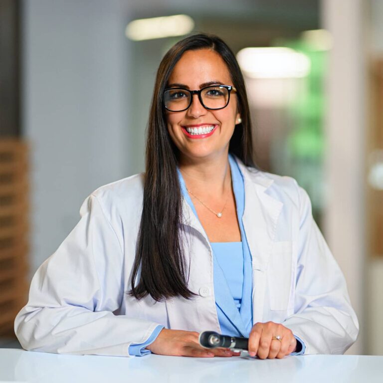 A female hearing care provider in a labcoat