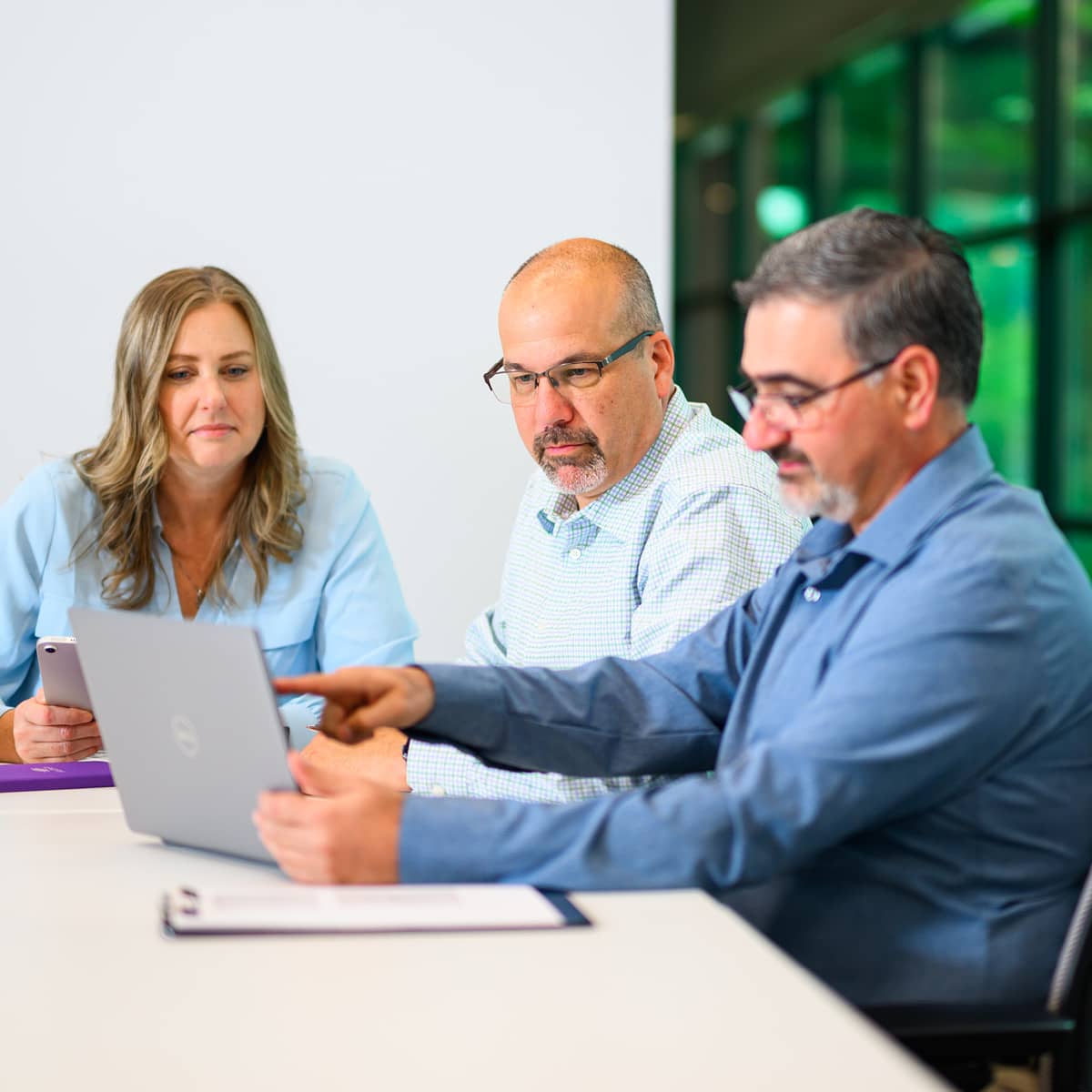 Three professionals in discussion