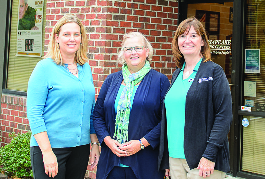 Hearing care professionals standing together outside in front the of the practice location.